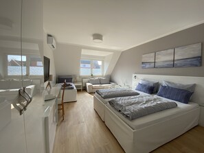 Habitación triple | Ropa de cama hipoalergénica, caja fuerte, escritorio y cortinas opacas