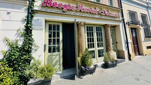 A building with a sign reading "Boogie Hostel Deluxe".