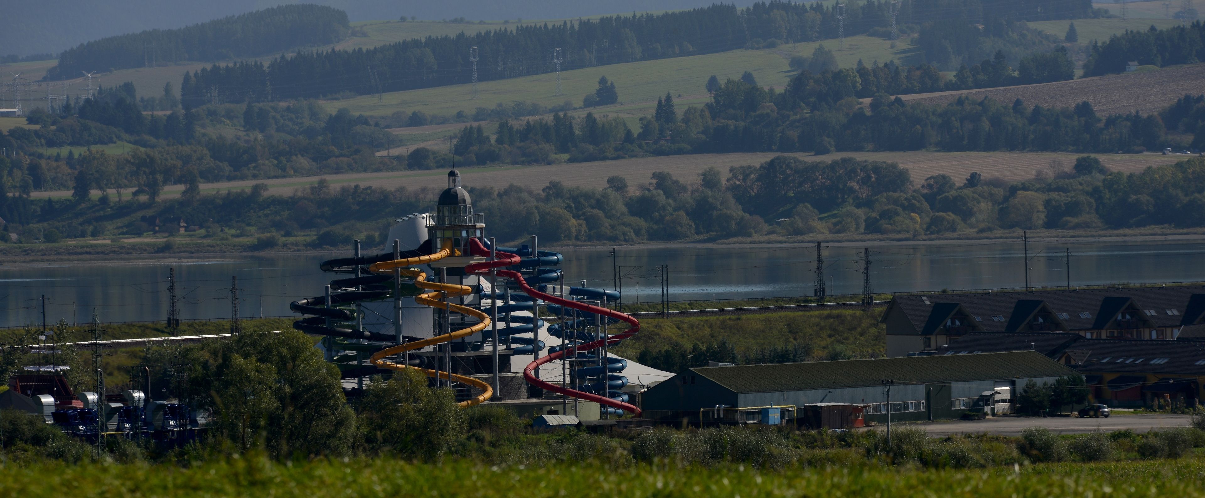 A water park with a large water slide and a viewing tower.