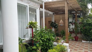 A covered patio area with potted plants and a wooden pergola. - Hospedaje Solymar Islas (San Andrés)