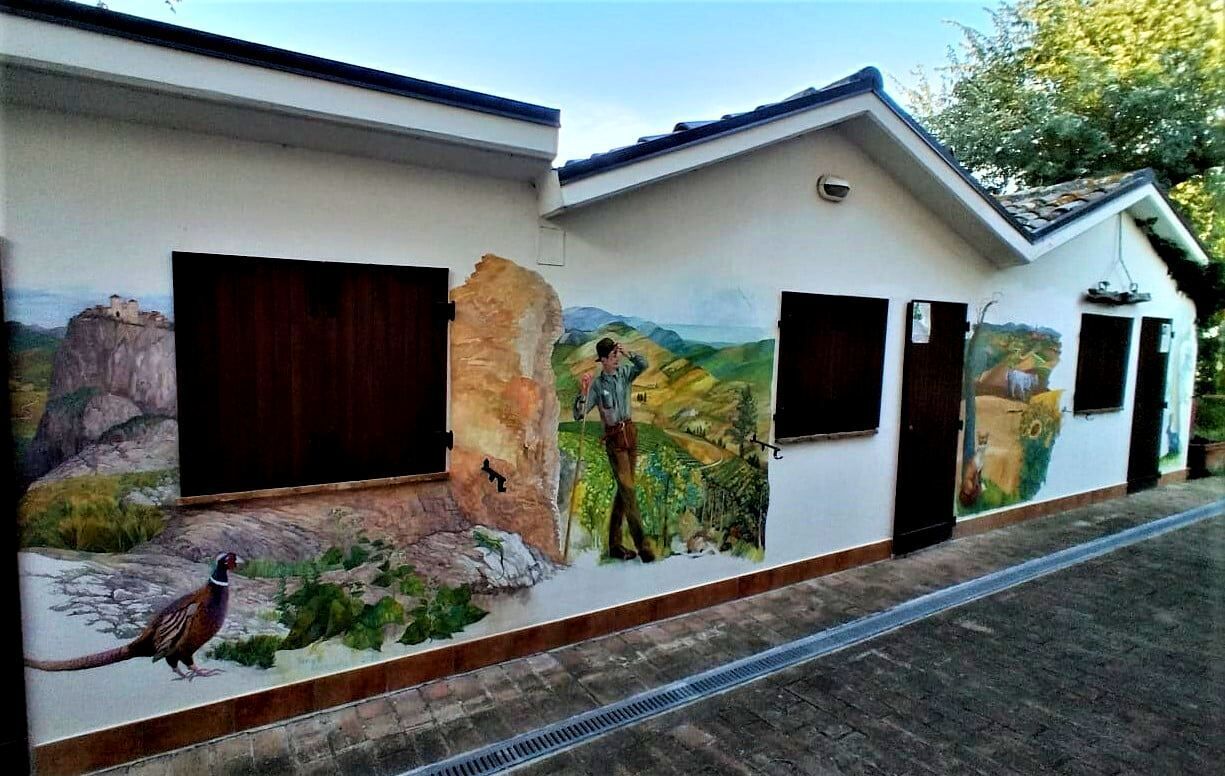 A building with a mural depicting a landscape and a person.