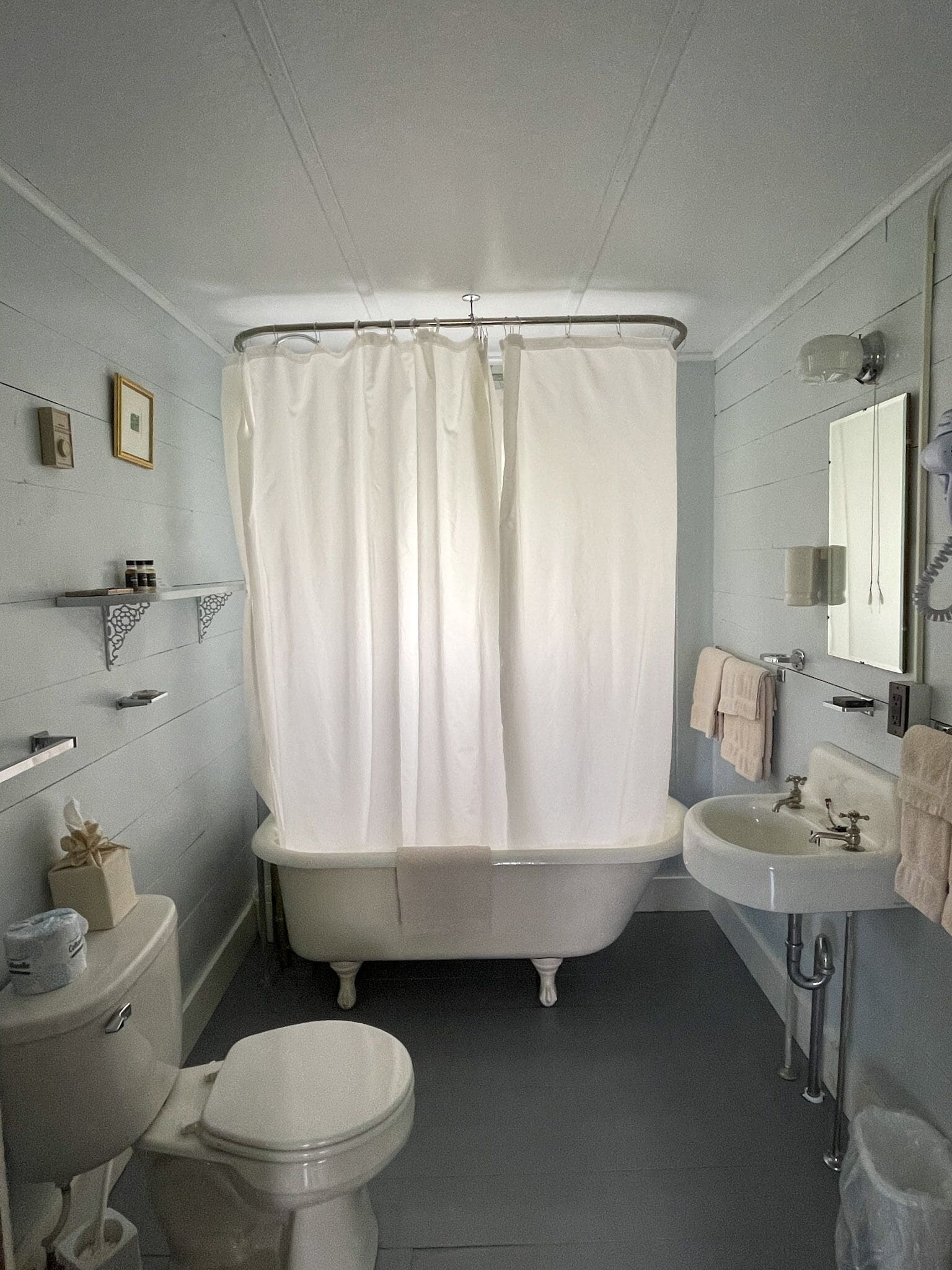 A bathroom with a bathtub, toilet, and sink.