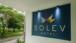 A sign for Solev Hotel with a modern design and a logo.