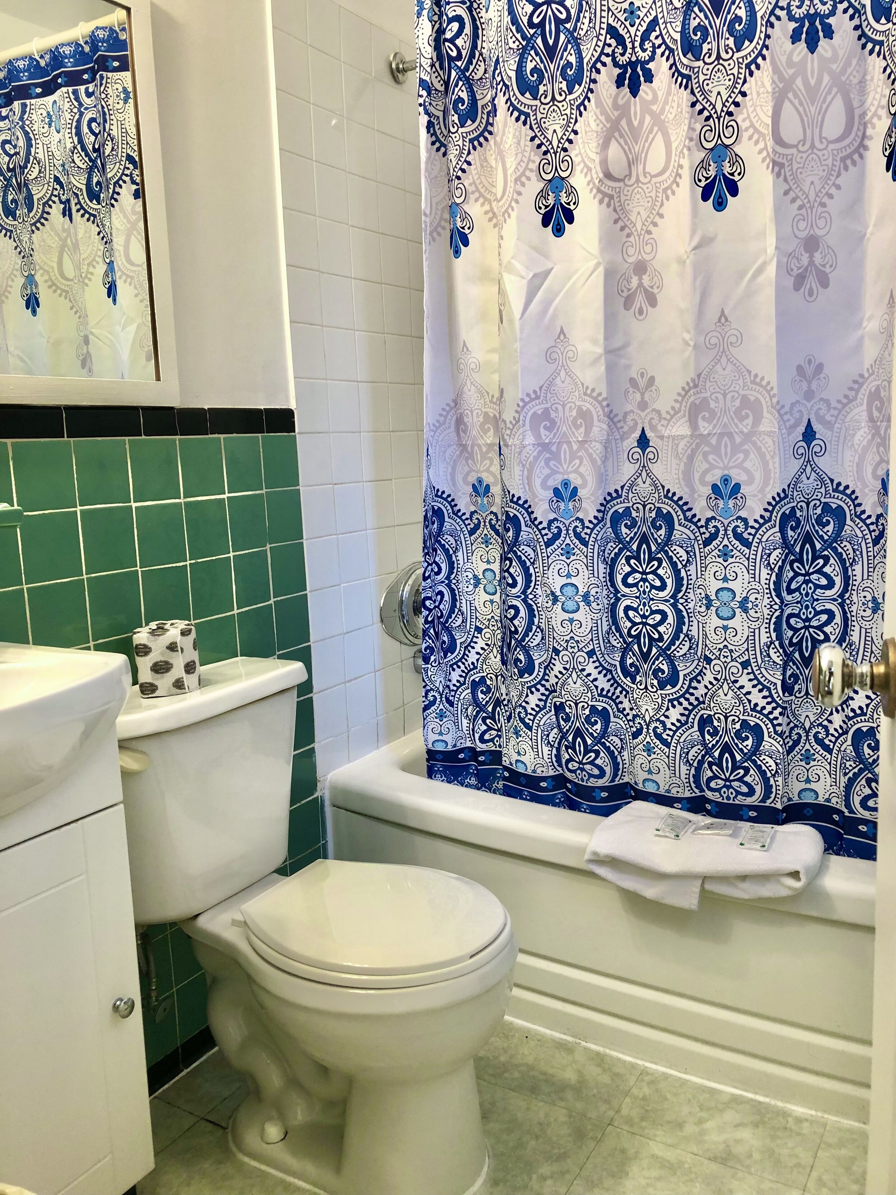 A bathroom with a toilet, a sink, and a bathtub.
