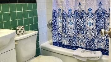A bathroom with a toilet, a sink, and a bathtub.