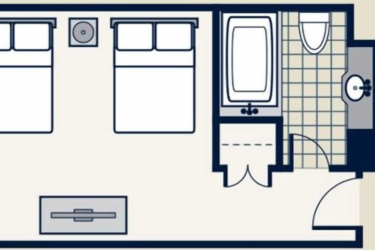 A bedroom with a bed, bedside tables, and a wardrobe.