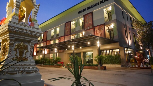 A hotel named "Green Garden Place" with a modern facade, multiple balconies, and a decorative entrance. - Green Garden Place (Udon Thani)