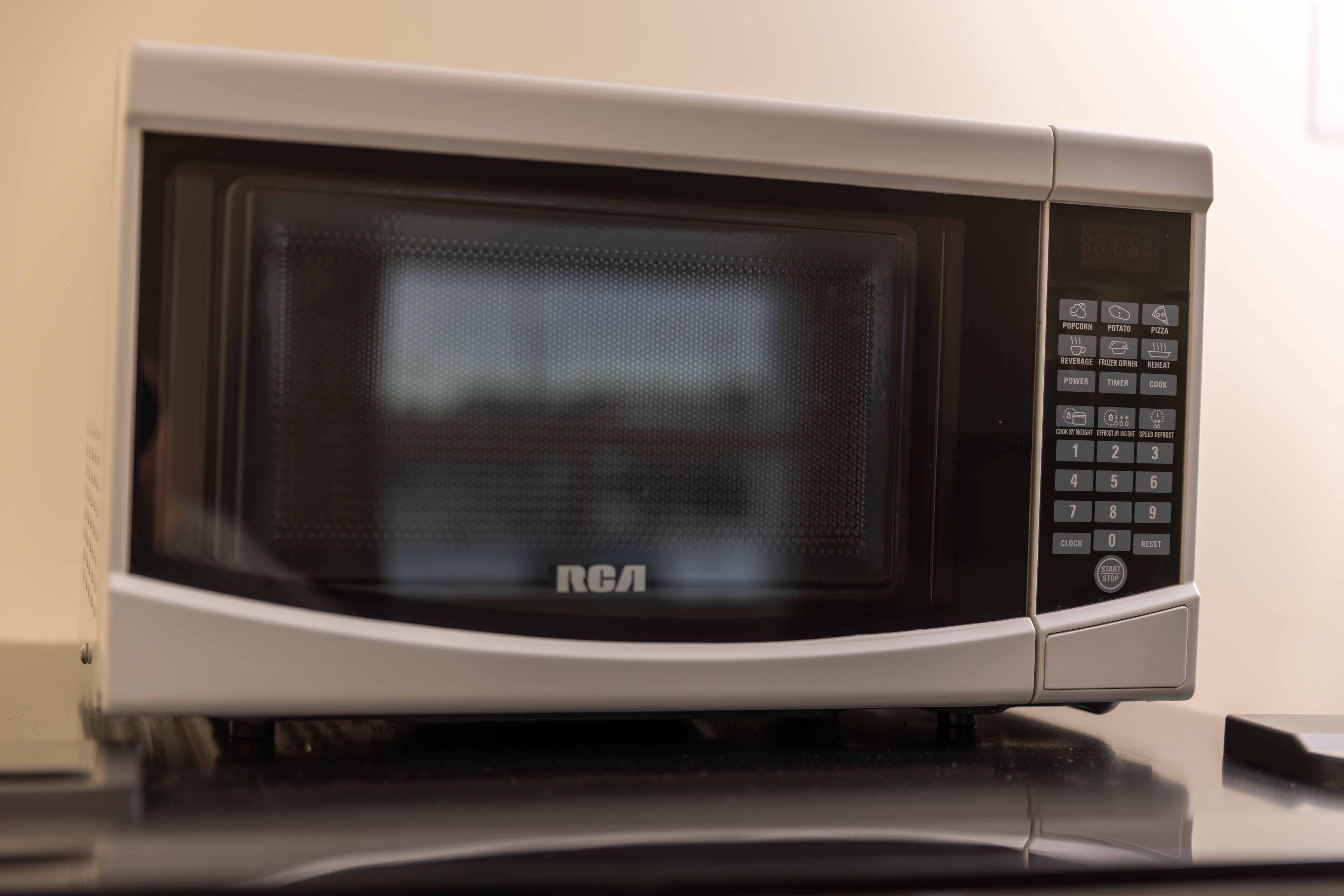 A microwave oven with a digital display and control panel.