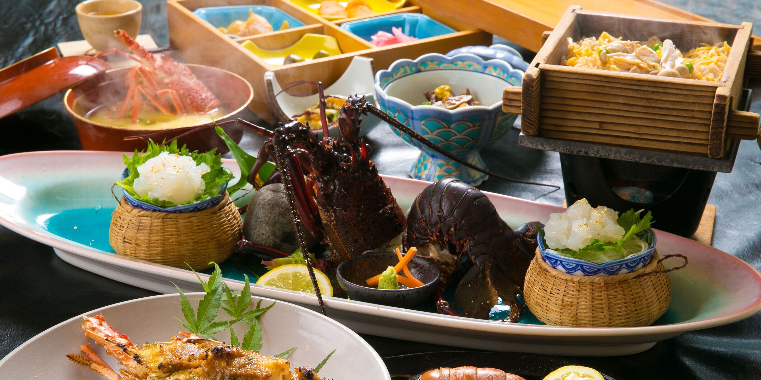 A seafood dish with lobster and shrimp, garnished with greens and lemon slices.