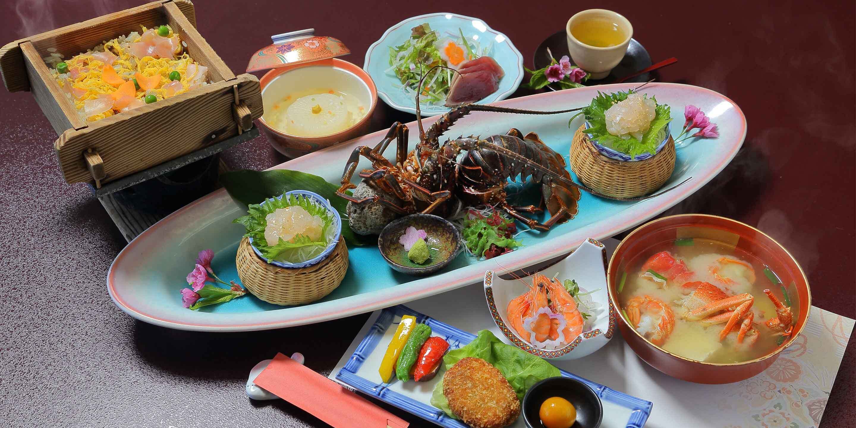 A seafood feast with various dishes including a lobster, shrimp, and rice.