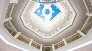 A multi-level atrium with a central skylight and geometric ceiling design.