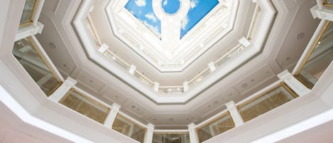 A multi-level atrium with a central skylight and geometric ceiling design.