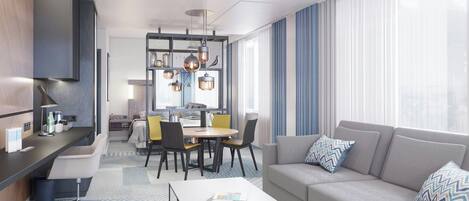 A modern hotel room with a sofa, a dining area, and a kitchen.