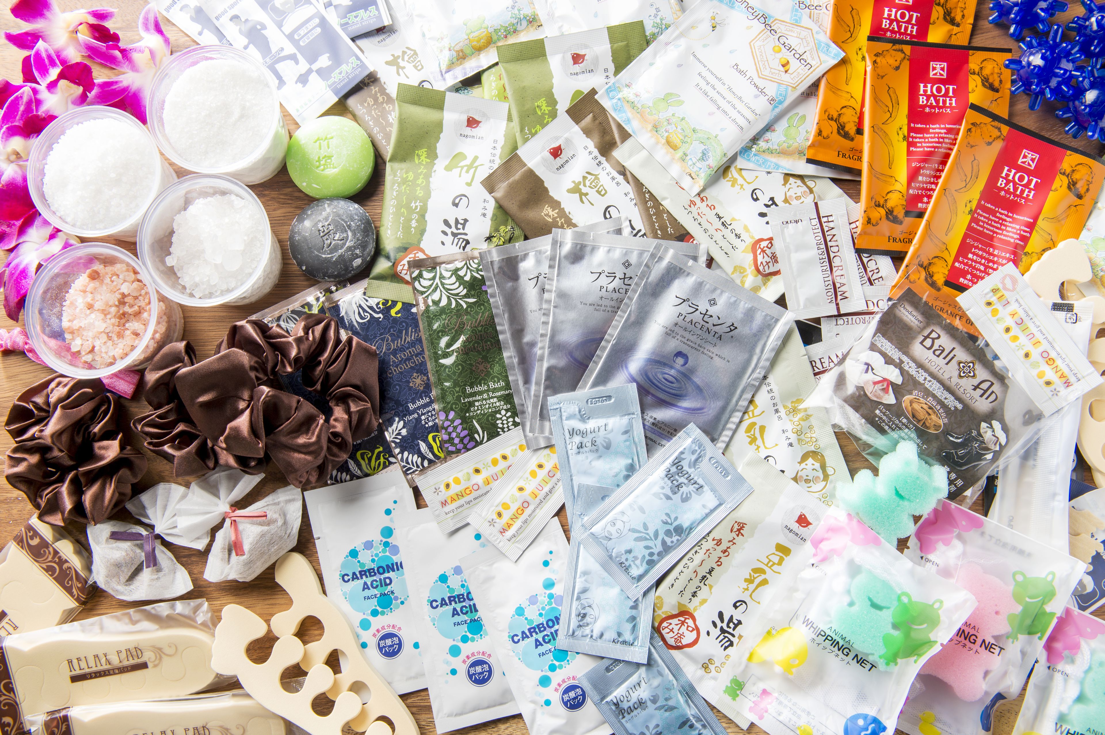 A variety of bath products including soaps, bath bombs, and bath salts.