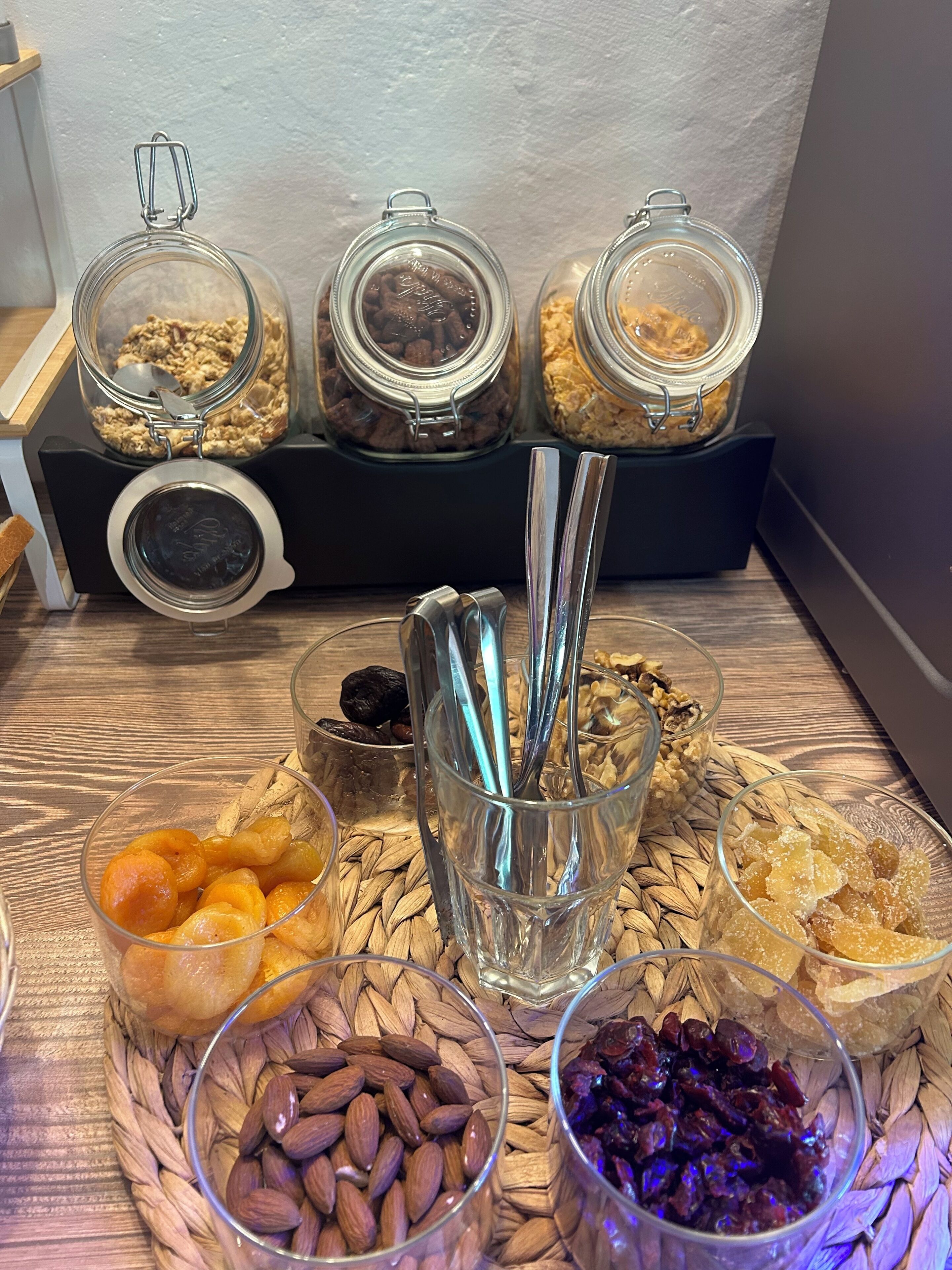 A table with various food items and containers, including jars and bowls.
