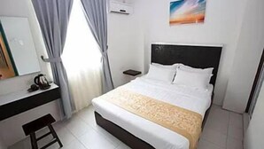 A hotel room with a bed, a desk, and a chair. - Skyview Hotel (Chukai)