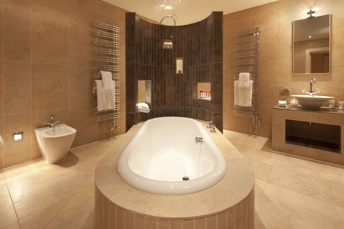 luxury room | bathroom | combined shower/bathtub, designer toiletries, hair dryer, towels