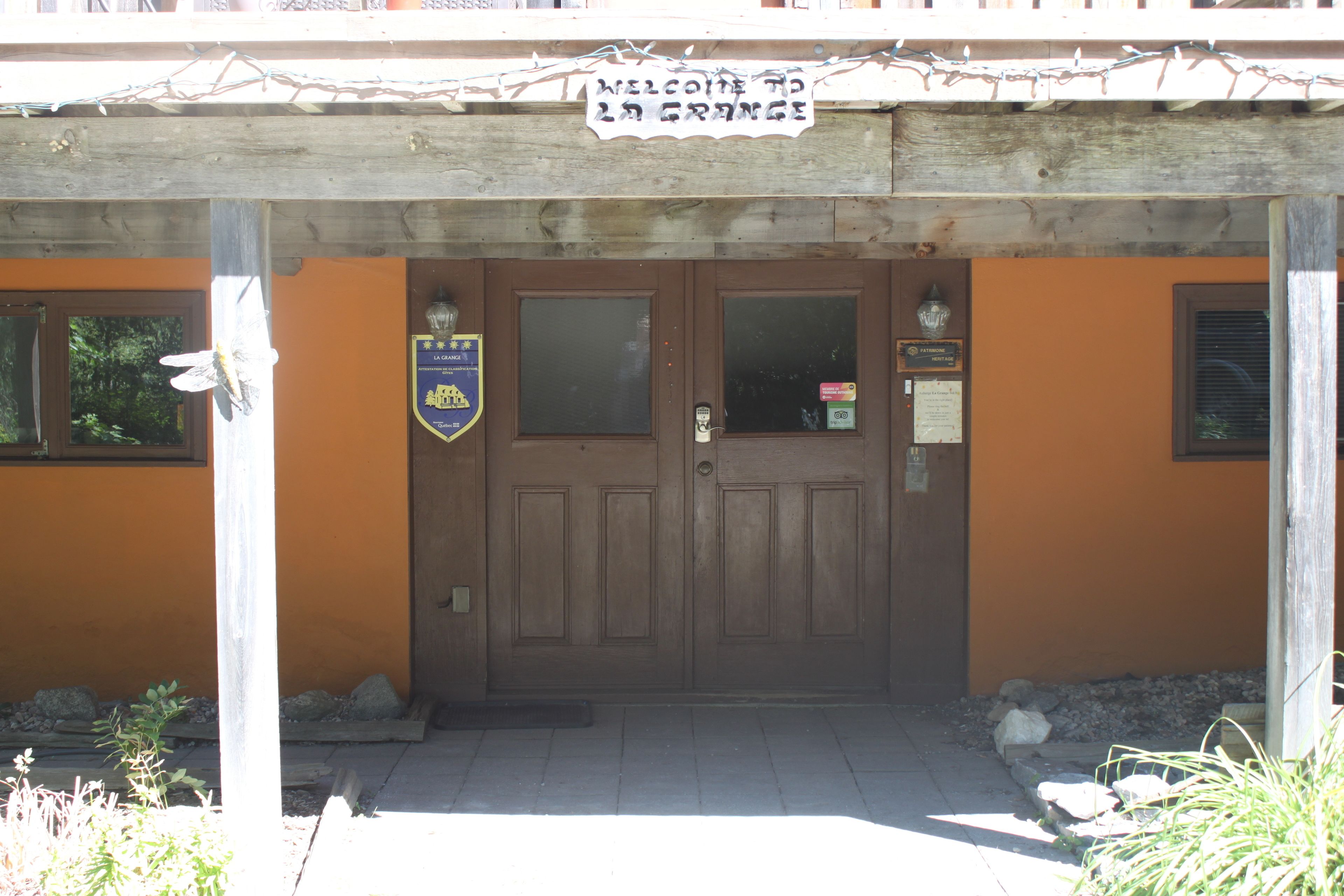 A wooden door with a sign above it.