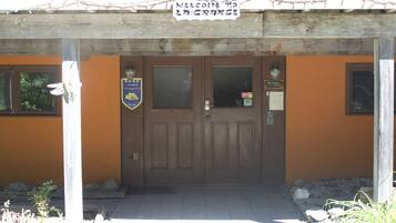 A wooden door with a sign above it.