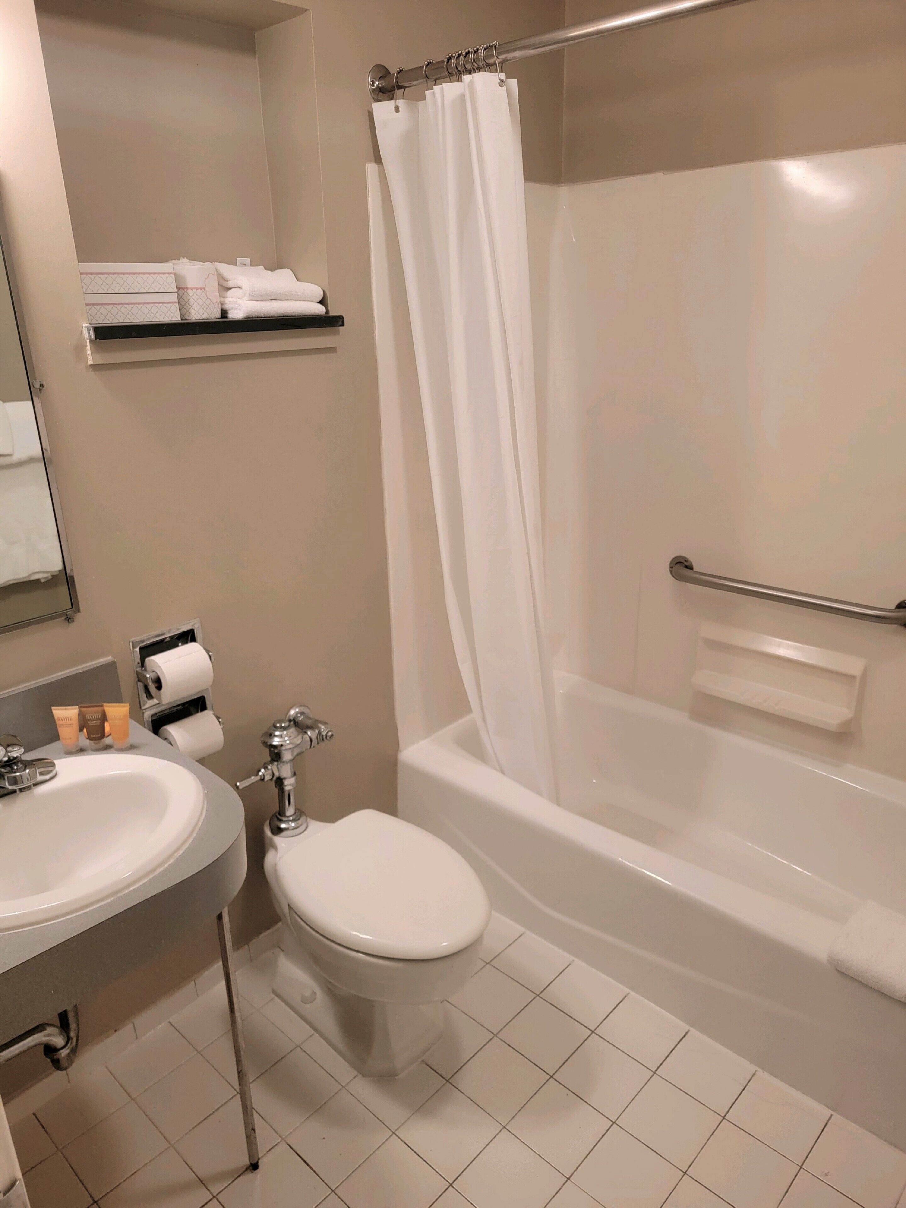 A bathroom with a sink, toilet, and bathtub.