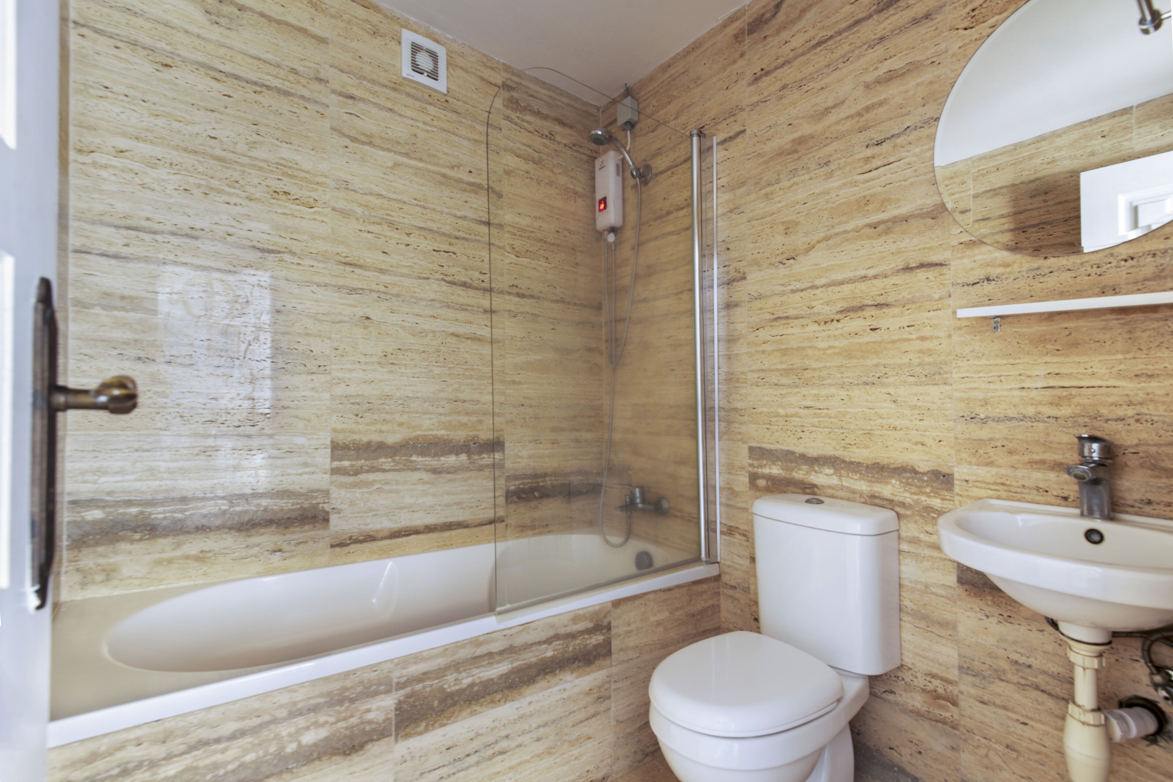 A bathroom with a bathtub, toilet, and sink.