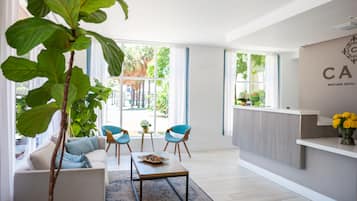 Welcome to our hotel lobby, featuring a reception desk, comfortable seating area, and expansive views of the outdoors.