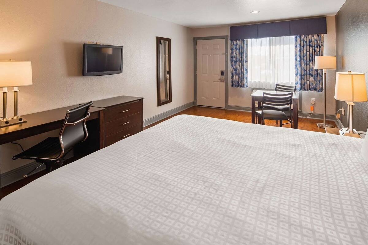 Premium bedding, desk, laptop workspace, blackout curtains