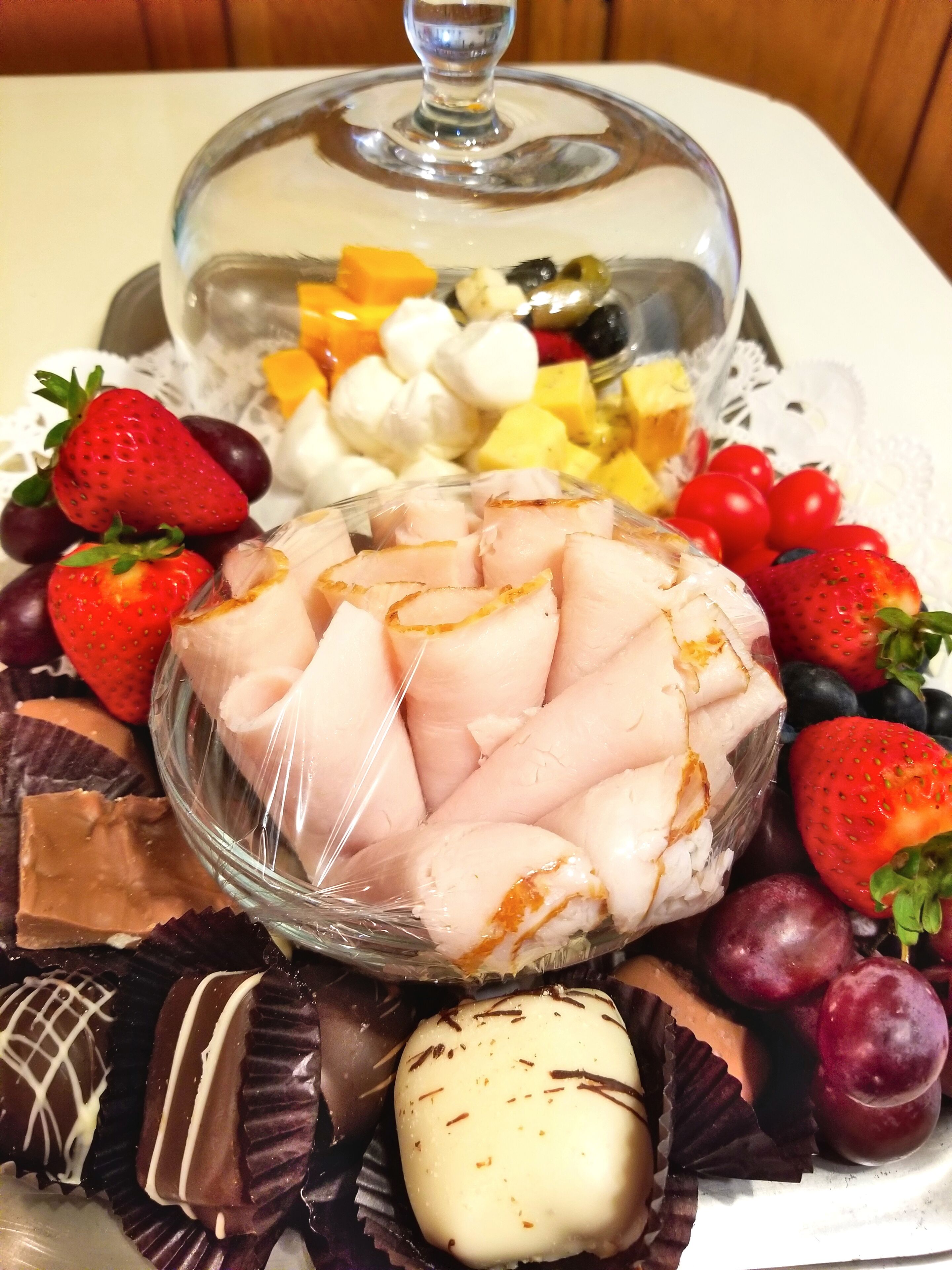 A dessert platter with various fruits and chocolates.