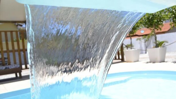A clear water feature with a smooth, reflective surface. - Pousada Água da Fonte (Florianópolis)