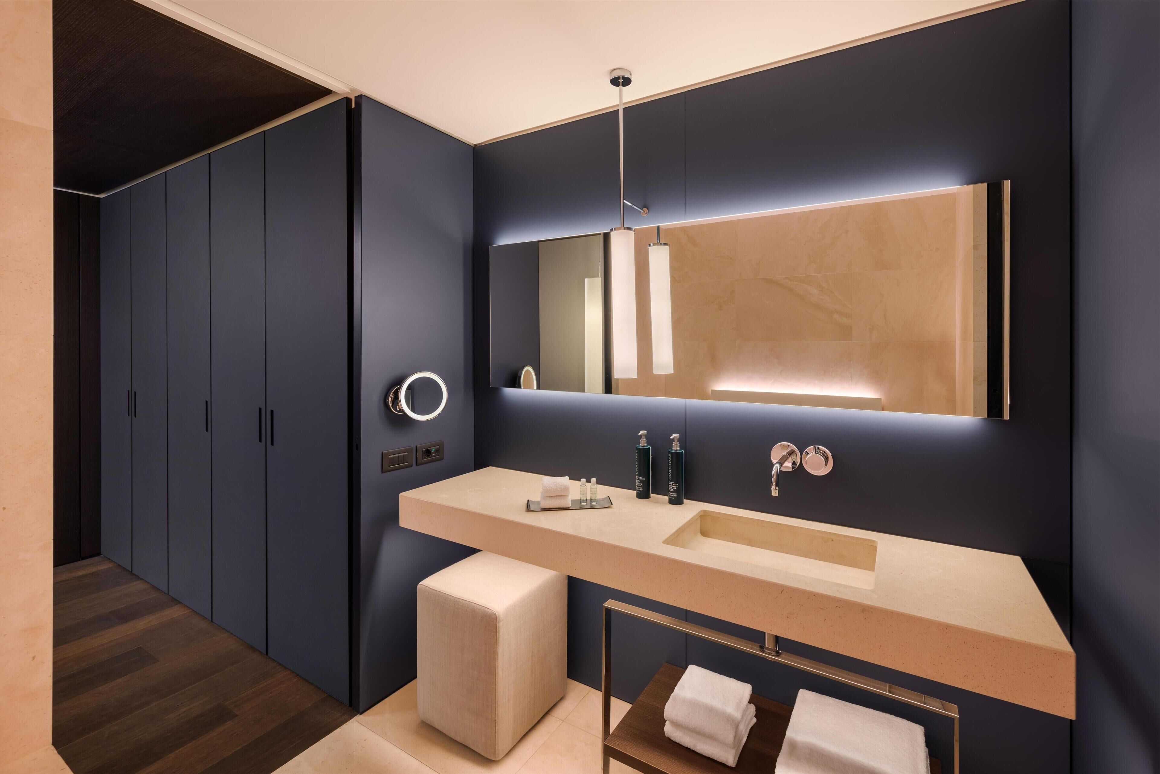 Un bagno moderno con un grande specchio, un lavabo doppio e un mobile bagno.