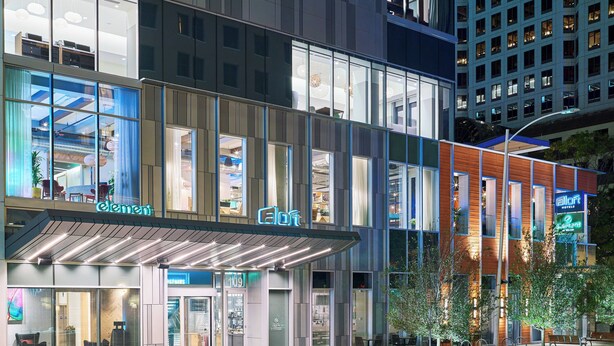 A modern hotel with a glass facade, outdoor seating, and a prominent 'Element' sign. - Aloft by Marriott Austin Downtown (Austin)