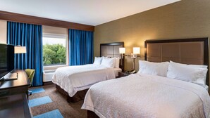 A hotel room with two beds, a desk, a TV, and a window with curtains. - Hampton Inn & Suites Duluth North/Mall Area (Duluth)