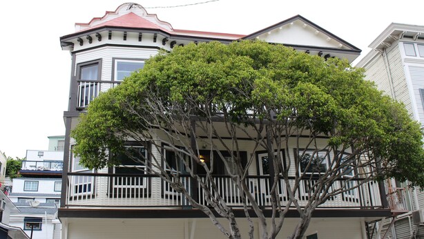 A two-story building with a bay window and a balcony. - Hermosa Hotel (Avalon)