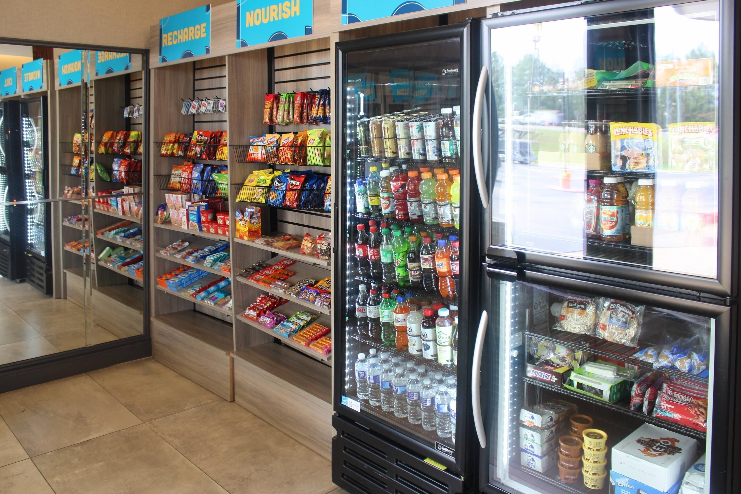 A refrigerated display case stocked with various beverages and snacks in a store.