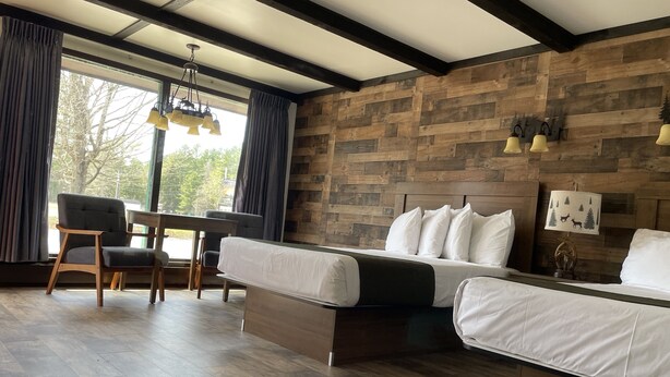 A room with a bed, a desk, and a chair. - Adirondack Lodge Old Forge (Thendara)