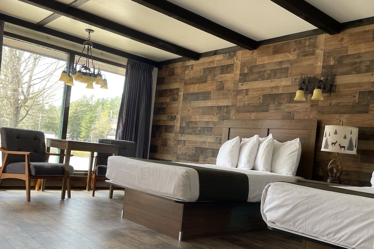 A room with a bed, a desk, and a chair.