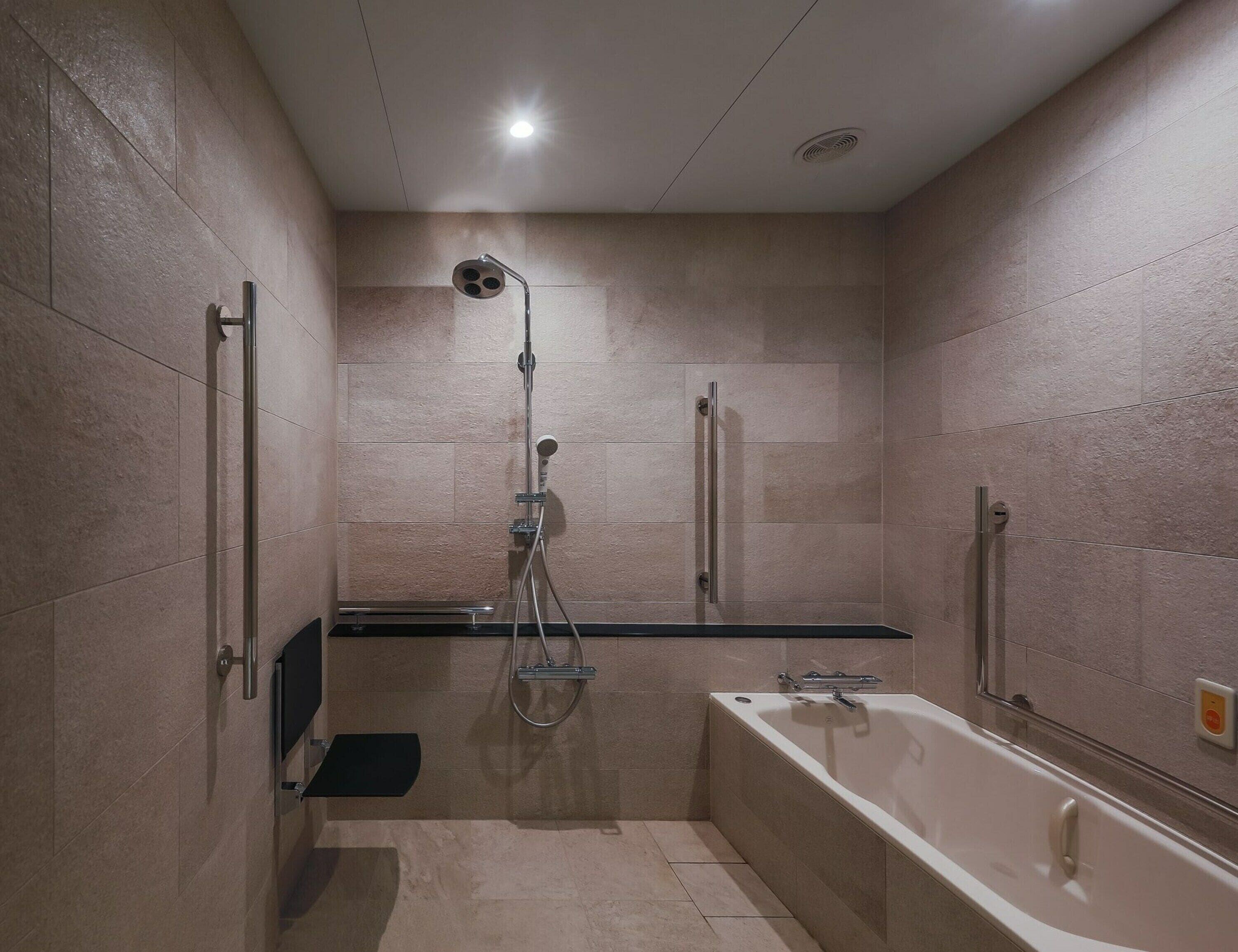 A modern bathroom with a shower, a bathtub, and a vanity.