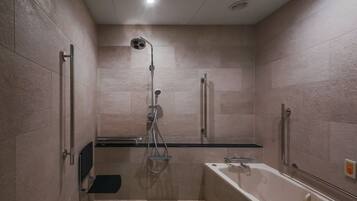 A modern bathroom with a shower, a bathtub, and a vanity.