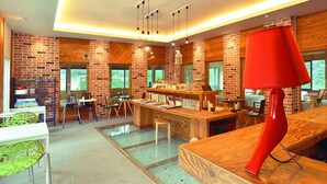 A modern kitchen with a brick wall, wooden counter, and a red lamp. - Skylake Pension (Hongcheon)