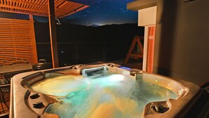 A hot tub with a starry night view, wooden deck, and a ladder. - Skylake Pension (Hongcheon)