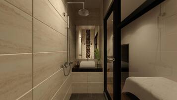 A modern bathroom with a shower, toilet, and sink.