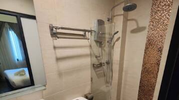 A bathroom with a toilet, sink, and shower.