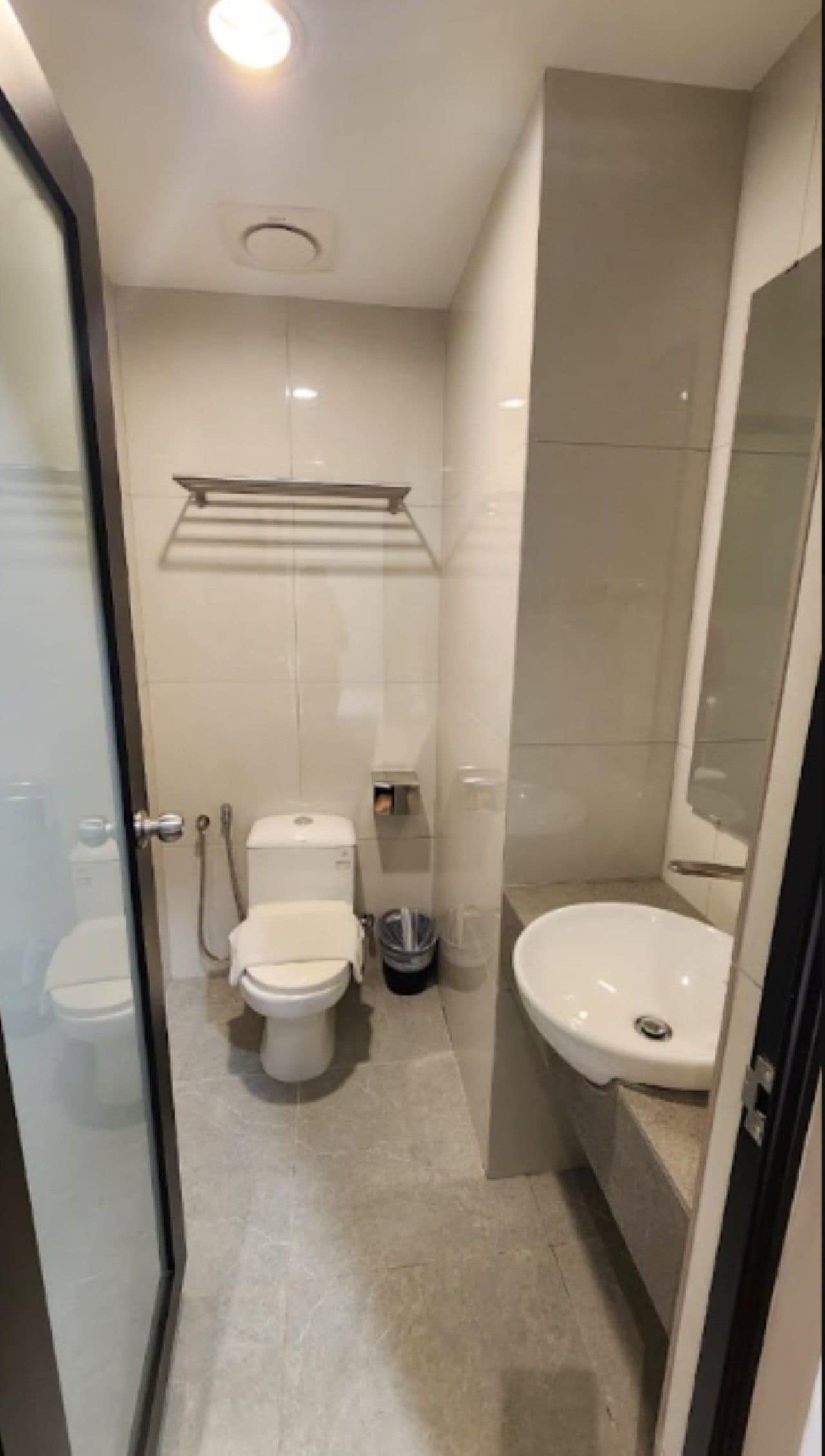 A modern bathroom with a toilet, bidet, and sink.