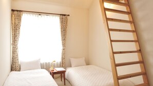 A small, cozy room with two beds, a wooden ladder, and a window with curtains.