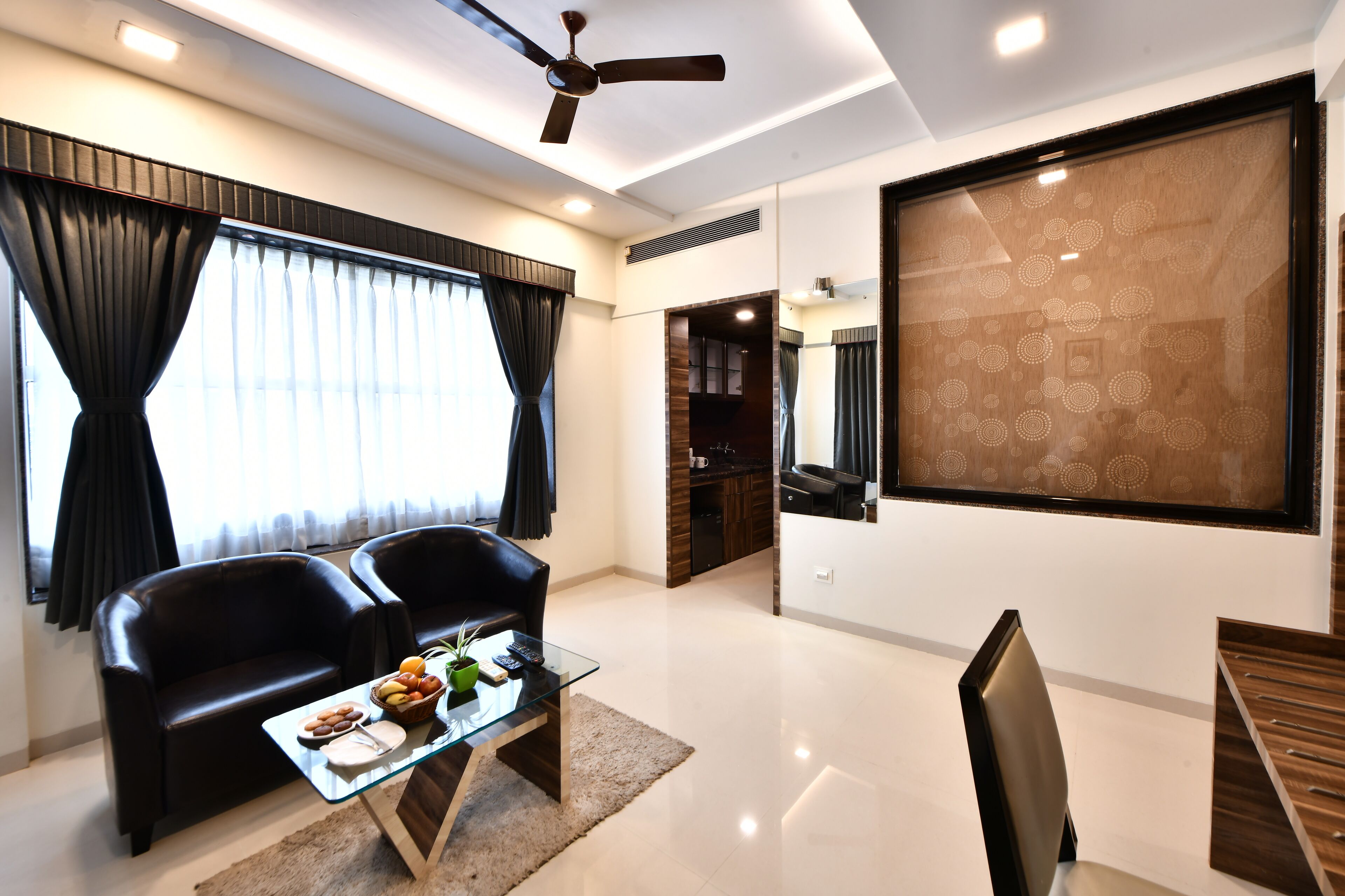 A modern living room with a sofa, coffee table, and a TV wall.