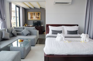 Family Suite, Multiple Beds, Balcony, Pool View | Living area | 32-inch LED TV with cable channels, TV