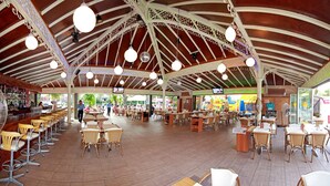 A spacious outdoor café with high ceilings, hanging lights, and a variety of seating arrangements including tables and chairs. - Prince Apart (Marmaris)