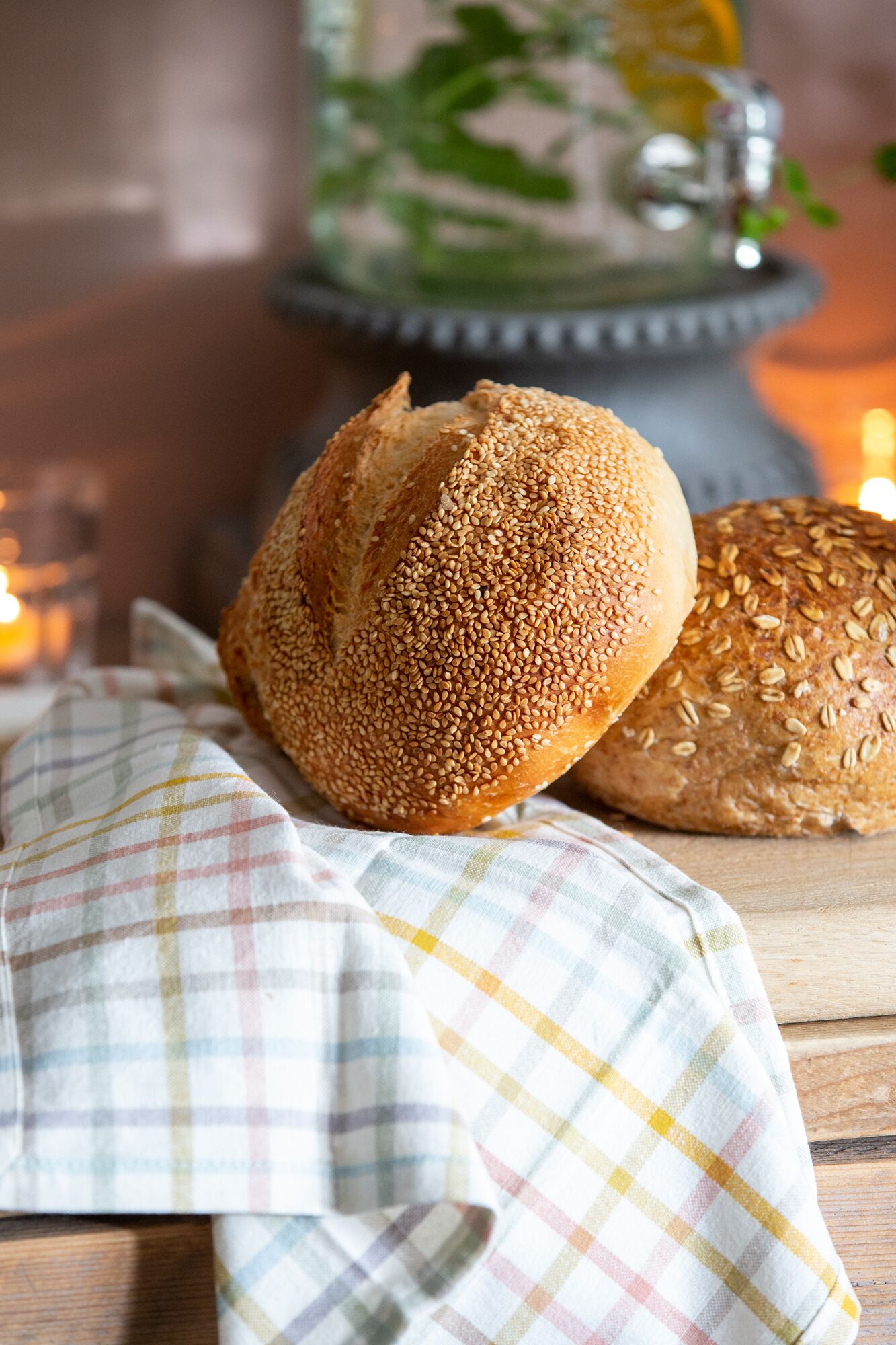A loaf of bread with sesame seeds on a wooden surface.