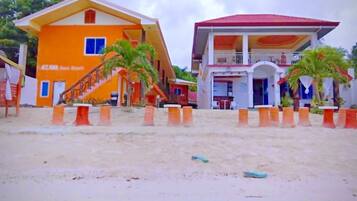 A two-story building with a red roof and a sign that reads "AZZONA Fresh Resort".
