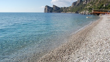 On the beach, sun-loungers, beach umbrellas, beach bar